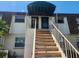 Condo building exterior showcasing a stairway leading to the entrance at 6128 Topher Trl # 6128, Mulberry, FL 33860