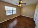 Spacious bedroom with wood-look floors and a ceiling fan at 6128 Topher Trl # 6128, Mulberry, FL 33860