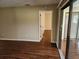 Living room with laminate flooring and access to screened porch at 6128 Topher Trl # 6128, Mulberry, FL 33860