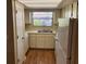 Galley kitchen with white cabinets and a window at 6128 Topher Trl # 6128, Mulberry, FL 33860