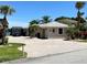 House with large driveway and mature landscaping at 648 Meandering Way, Polk City, FL 33868