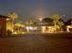 Landscaped yard beautifully lit at night at 648 Meandering Way, Polk City, FL 33868