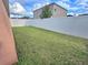 Large backyard with a grassy area and white vinyl fence at 1109 Brenton Manor Dr, Winter Haven, FL 33881
