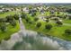 Aerial view of a neighborhood with houses and a lake at 515 E Square Lake Dr, Bartow, FL 33830