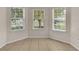 Bright breakfast nook features three windows and tile flooring at 6838 Glenbrook Dr, Lakeland, FL 33811