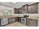 Kitchen with dark wood cabinets and stainless steel appliances at 6838 Glenbrook Dr, Lakeland, FL 33811