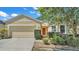 Tan house with two-car garage and manicured landscaping at 6838 Glenbrook Dr, Lakeland, FL 33811