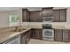 Kitchen with dark wood cabinets and stainless steel appliances at 6838 Glenbrook Dr, Lakeland, FL 33811