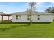 White house back with a pergola and grassy yard at 1618 Birchwood Loop, Lakeland, FL 33811