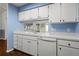 Bright kitchen with white cabinets, built in dishwasher and laminate flooring at 1618 Birchwood Loop, Lakeland, FL 33811