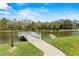 Lakefront dock with seating and fountain view at 1618 Birchwood Loop, Lakeland, FL 33811