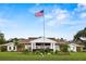 Brick community center with landscaping and flag at 1618 Birchwood Loop, Lakeland, FL 33811