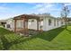 Home with backyard patio and wooden pergola at 1618 Birchwood Loop, Lakeland, FL 33811