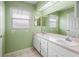 Bathroom with double vanity and a large mirror at 1618 Birchwood Loop, Lakeland, FL 33811