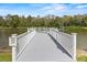 White dock with seating overlooking a tranquil lake at 1618 Birchwood Loop, Lakeland, FL 33811