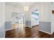 Dining room with hardwood floors and a view into the kitchen at 1618 Birchwood Loop, Lakeland, FL 33811