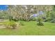 Large backyard with lush lawn and mature oak tree at 1705 Davis Ave, Bartow, FL 33830