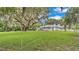 Spacious backyard with mature oak tree and home at 1705 Davis Ave, Bartow, FL 33830
