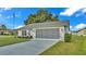 Single story home with gray roof, white walls, and gray screened garage doors at 6202 Peacock Run, Lakeland, FL 33809