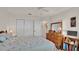 Well-lit bedroom with double doors and wood dresser at 6202 Peacock Run, Lakeland, FL 33809