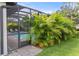 Relaxing screened pool enclosure with paved patio and lush landscaping at 4020 Prima Lago Cir, Lakeland, FL 33810