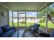 Relaxing screened porch with wicker furniture, offering a peaceful outdoor space at 4829 Colonnades E Cir, Lakeland, FL 33811