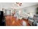 Bright living room with hardwood floors, light colored furniture, and access to backyard at 4829 Colonnades E Cir, Lakeland, FL 33811