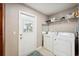 Laundry room with washer, dryer, and built-in shelving at 4829 Colonnades E Cir, Lakeland, FL 33811