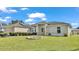 Single-story house with solar panels, attractive landscaping, and a circular driveway at 7454 Briarbay Loop, Lakeland, FL 33810