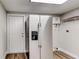 Laundry room with refrigerator, water heater, and shelving at 2429 Lakeview St, Lakeland, FL 33801