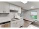 Modern kitchen with white cabinets, quartz countertops, and stainless steel sink at 2429 Lakeview St, Lakeland, FL 33801