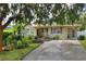 Front view of charming ranch house with mature landscaping at 1819 Meadowbrook Ave, Lakeland, FL 33803