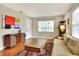 Living room featuring hardwood floors, a neutral color palette, and mid-century modern decor at 1819 Meadowbrook Ave, Lakeland, FL 33803