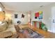 Living room with hardwood floors, neutral walls, and mid-century modern furniture at 1819 Meadowbrook Ave, Lakeland, FL 33803