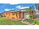 Orange house exterior with garage and landscaping at 4390 Sunnyside Dr, Lakeland, FL 33810