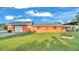 Ranch-style home with orange exterior and carport at 4390 Sunnyside Dr, Lakeland, FL 33810