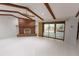 Spacious living room with exposed beams, fireplace, and sliding glass doors at 4428 Sugartree E Dr, Lakeland, FL 33813