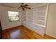Home office with built-in shelving and hardwood floors at 4428 Sugartree E Dr, Lakeland, FL 33813
