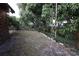 Large backyard with mature trees and a partially grassy area at 4428 Sugartree E Dr, Lakeland, FL 33813