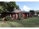 Brick ranch home with red front door at 4428 Sugartree E Dr, Lakeland, FL 33813