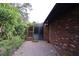 Brick patio adjacent to a sunroom and brick home exterior at 4428 Sugartree E Dr, Lakeland, FL 33813