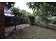 Backyard with a covered patio area and lush landscaping at 4428 Sugartree E Dr, Lakeland, FL 33813