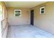 Covered front porch with concrete flooring and wooden lattice at 608 Lark Dr, Lakeland, FL 33813