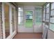 Bright, screened porch with multiple windows and access to backyard at 608 Lark Dr, Lakeland, FL 33813
