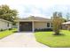 Tan single-story house with carport and well maintained lawn at 608 Lark Dr, Lakeland, FL 33813