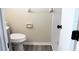 Clean bathroom with toilet, shower, and wood-look floors at 608 Lark Dr, Lakeland, FL 33813