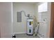 Laundry room with water heater and shelving at 608 Lark Dr, Lakeland, FL 33813