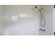 Shower with white tiled walls and a handheld shower head at 608 Lark Dr, Lakeland, FL 33813