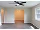 Open living room with neutral decor and access to another room at 608 Lark Dr, Lakeland, FL 33813