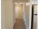 Hallway with light walls, wood-look flooring, and white doors at 608 Lark Dr, Lakeland, FL 33813
